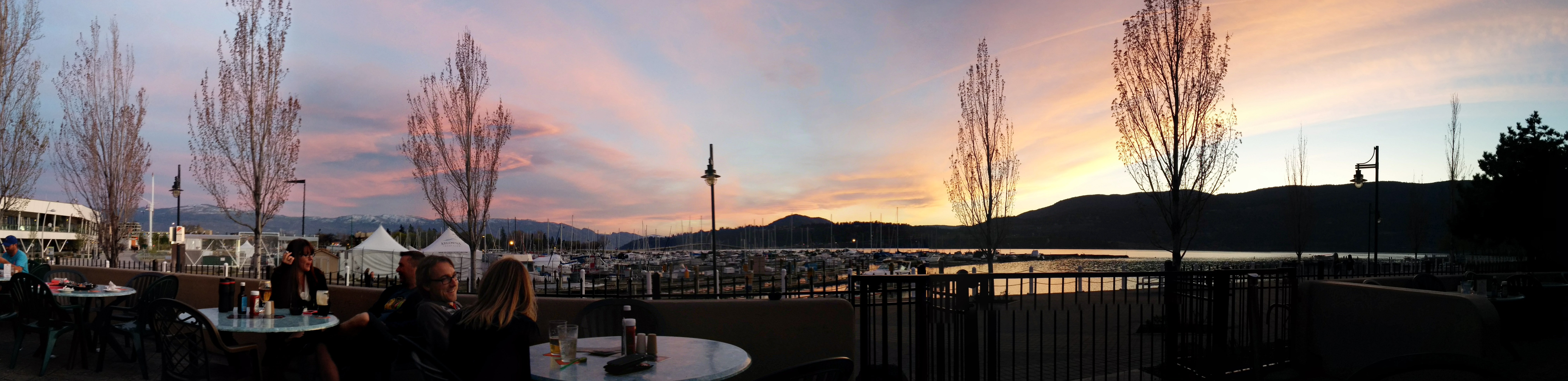 This photo is a banner photo depicting a patio overlooking the Kelowna Yacht club in British Columbia.
